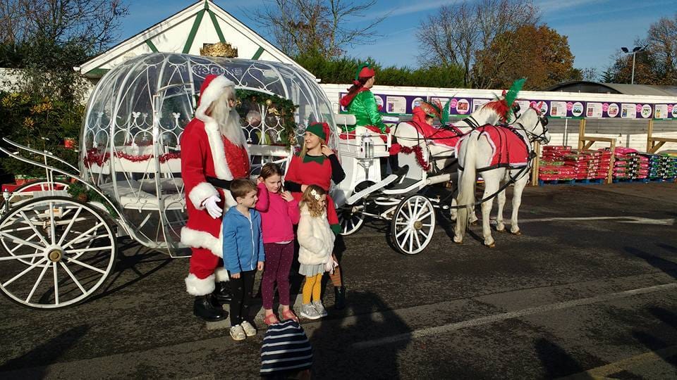Father Christmas and children beside the Cinderella carriage